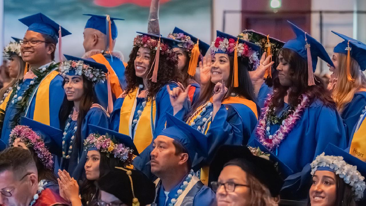 Graduation picture with students lined up in caps and gowns